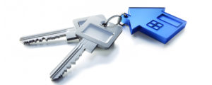 a house shaped keychain with 2 keys