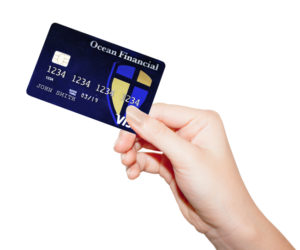 Hand holding an OFFCU Visa Credit Card